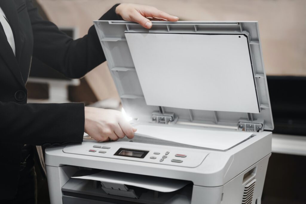 Business woman is using the printer to scanning